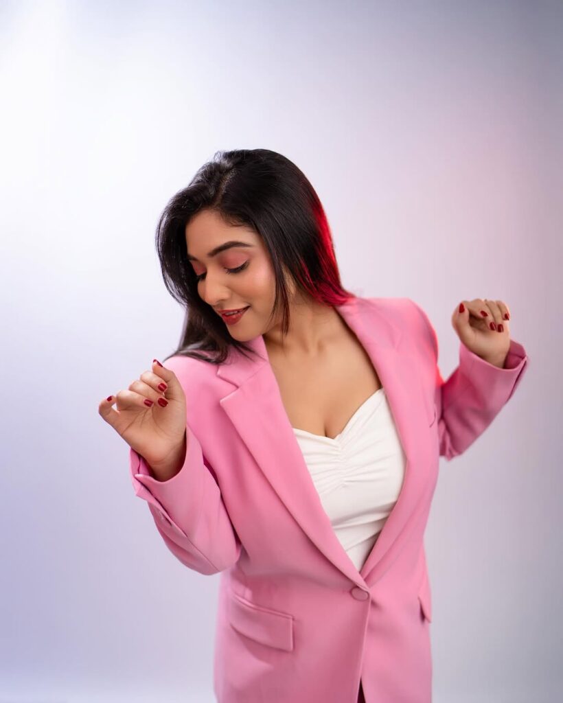 Priyanka Thimmesh looking confident in a pink blazer outfit with red highlights
