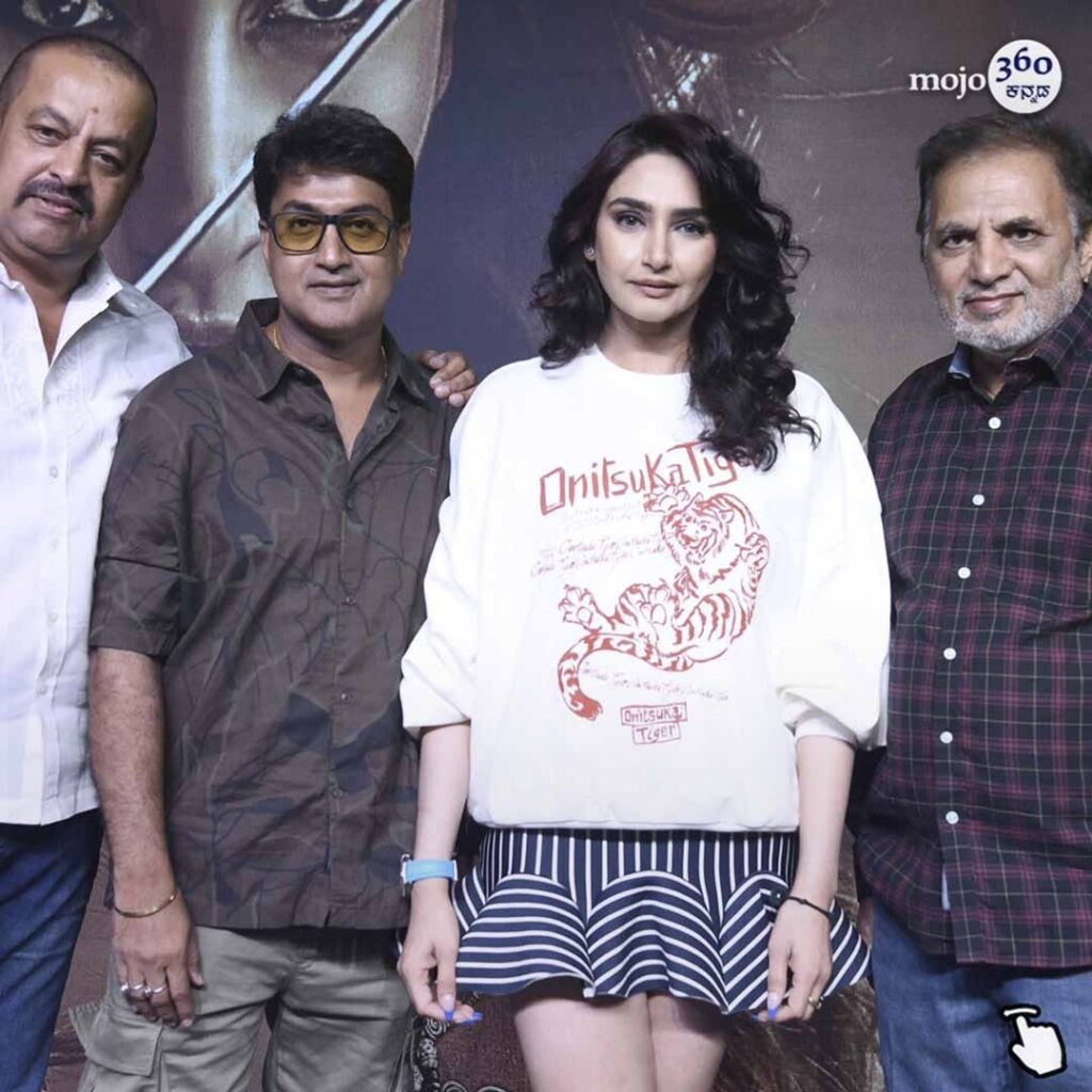 Actress Ragini Dwivedi looking powerful and glamorous in a black sequined dress at the Madanika Kannada film teaser launch event.