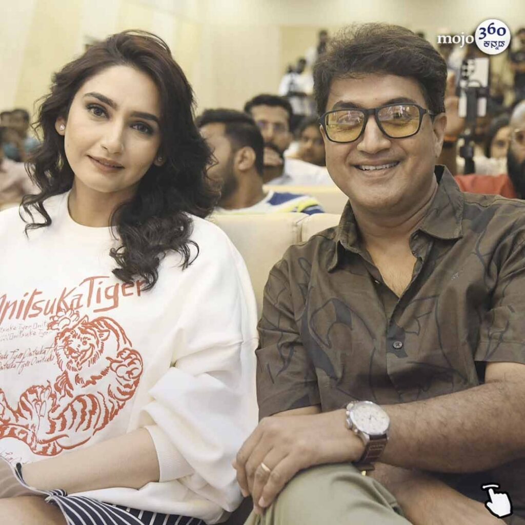 Actress Ragini Dwivedi looking powerful and glamorous in a black sequined dress at the Madanika Kannada film teaser launch event.