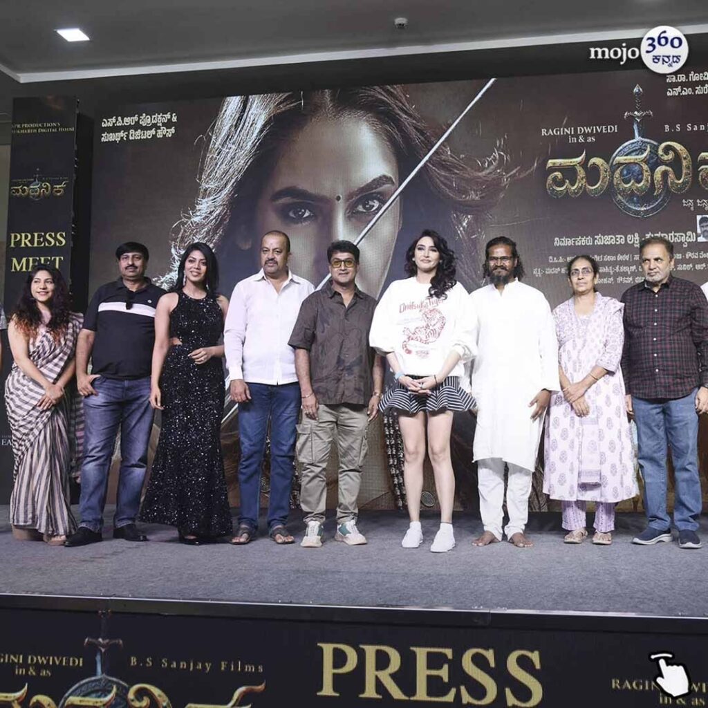 Actress Ragini Dwivedi looking powerful and glamorous in a black sequined dress at the Madanika Kannada film teaser launch event.